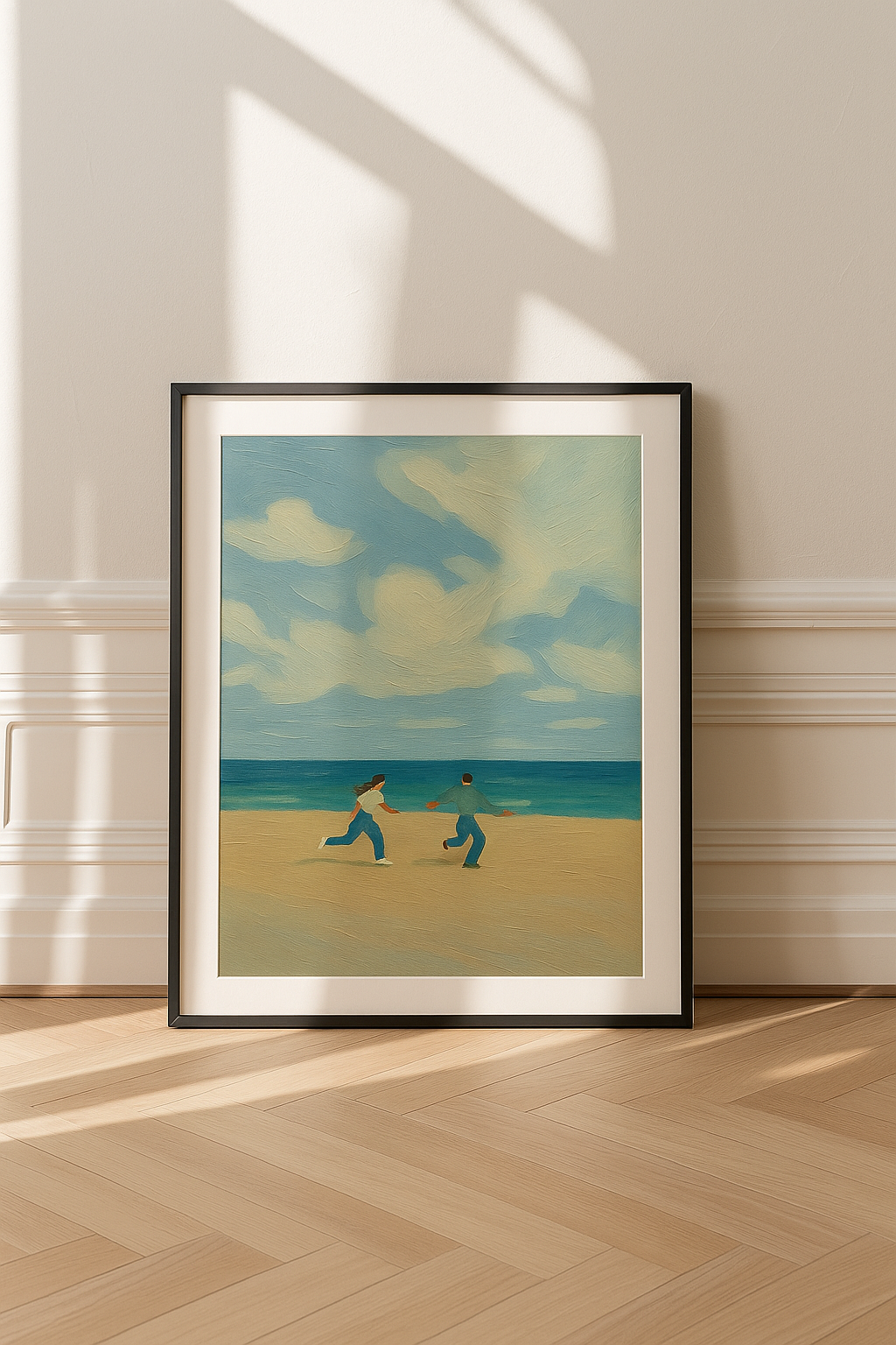 Framed artwork of two people on a beach with a blue sky, displayed on a wall.