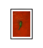 Minimalist wall art of two green parrots resting in a hollow on a vibrant red textured background.