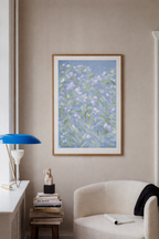 Blue botanical wall art with white and lavender flowers